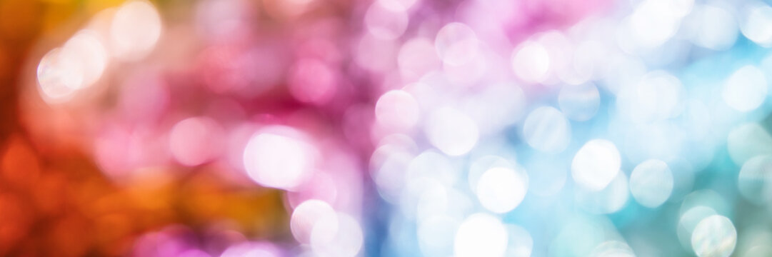 Blurred bokeh background for Christmas and New Year holiday. Abstract colorful wallpaper with defocused lights. Copy space. Banner
