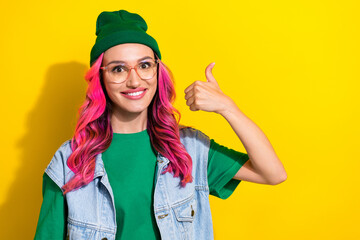 Photo of positive lady wear green beanie stylish outfit hand thumb up quality clothes empty space isolated on yellow color background