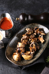 Grilled vegetables. Fried mushrooms with herbs on a plate, red and white sauces, ketchup, spices. Rosemary on a dark table. Turkish cuisine, dish. Vegetable garnish. Background image, copy space