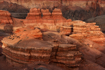Fragment of the red sandy-clay canyon Charyn, figures of the canyon, erosion, lateral sun