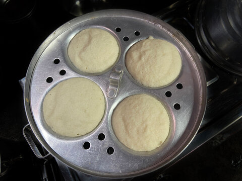 Fresh hot steaming idli in a hot oven.