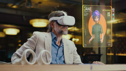 Middle aged man with VR headset communicates with virtual character avatar in the metaverse...