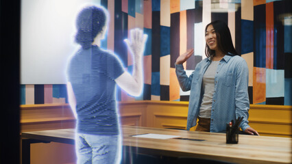 Asian woman talks on the call with her friend using augmented reality software. Hologram of her...
