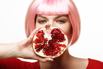 Girl with pomegranate. Pink hair. - 536377967