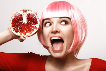Explosive discounts, grenades. Girl with pomegranate. Pink hair. Makeup. - 536377994