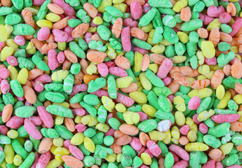 Colorful puffed rice sweets. Background of rainbow drops cand isolated on white background