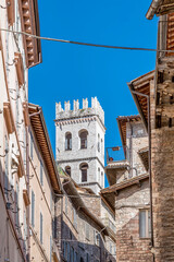 The ancient Torre del Popolo, tower of the people, historic center of Assisi, Perugia, Italy, stands out over the surrounding buildings