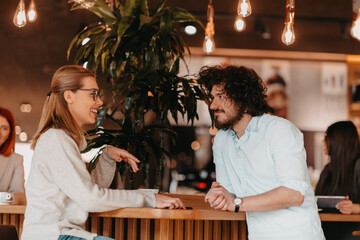 Business couple sits in a cafe after a weekday.