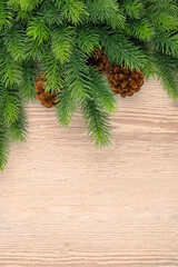 Christmas wooden background with fir tree.Light brown wooden background. Christmas decor, garland with Rustic Background