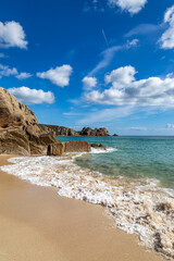 Rock formations and the sandy beach, at Porthcurno on the south coast of Cornwall