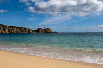Fototapeta na wymiar The idyllic beach at Porthcurno in Cornwall, on a sunny day