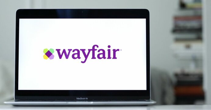 Logo design of wayfair on a laptop screen in blurred background