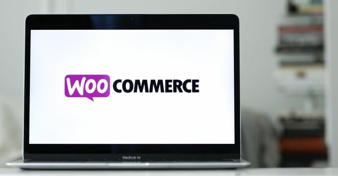 Logo design of woocommerce on a laptop screen in blurred background