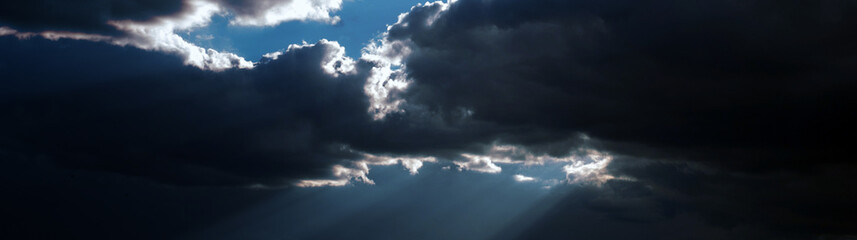 Obraz premium Heavy gloomy dim thunderclouds. Dark dramatic sky. Storm. Toned cloudy sky background with space for design. Web banner. Wide. Site title.