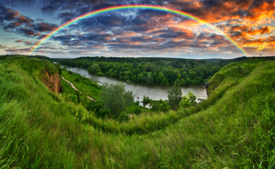 Fototapeta premium Landscape with a Rainbow on the River in Spring. colorful morning. nature of Ukraine