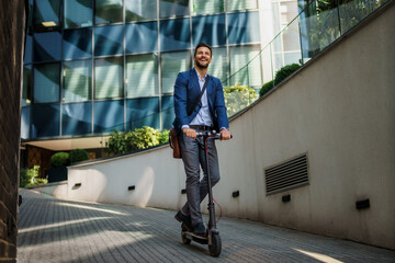 Young business man in a suit riding an electric scooter on a business meeting. Ecological transportation concept - Powered by Adobe