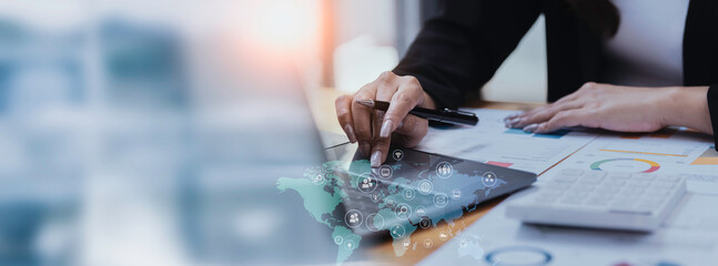 Technology and financial advisory services concert. Business teamwork and working on digital laptop computer with advisor showing plan of investment to clients at table office. Digital marketing.