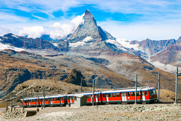 Gornergrat Bahn going up to the Gornergrat train station near Zermatt. Matterhorn peak (also called...