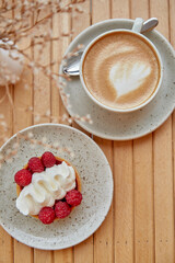 Aesthetic french tart and cup of cappuccino flat lay. Atmospheric breakfast.