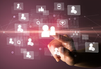 Hand pressing social media multimedia application screen with media icons on futuristic concept