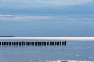 Breakwater in the calm sea with blue sky
