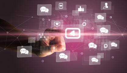 Hand pressing social media multimedia application screen with media icons on futuristic concept