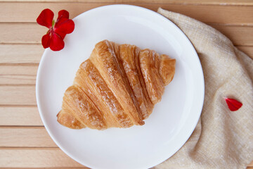Aesthetic breakfast - french traditional crust fresh croissant close up outside. Top view food