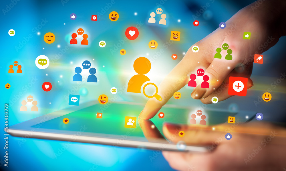 Poster close-up of a hand using tablet with social media icons