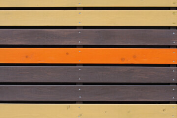 Colourful (yellow, orange and brown) wooden background from horizontal planks with nails