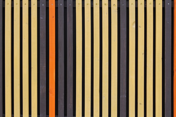 Colourful (yellow, orange and brown) wooden background from vertical planks with nails