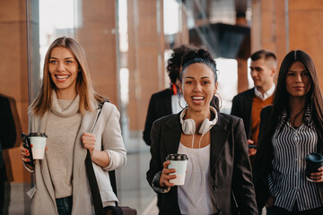 Travelers business team of colleagues walking and talking on modern urban city streets. People on out of the office on break. 