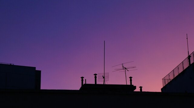 Closeup shot of silhouettes of old buildings against a beautiful gradient sunset