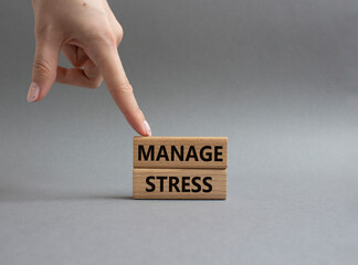 Manage stress symbol. Concept word Manage stress on wooden blocks. Beautiful grey background. Doctor hand. Business and Manage stress concept. Copy space