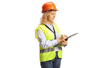 Female engineer with a safety vest and helmet writing a document