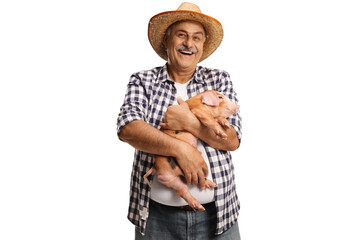 Mature farmer holding a little pig and smiling