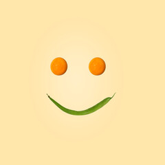 Eating is a pleasure. Smiling face made of green beans and yolks. Graphics on a light beige...