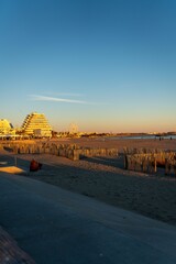 Fototapeta premium Vertical shot of the La Grande Motte by the shore of the beach during sunset