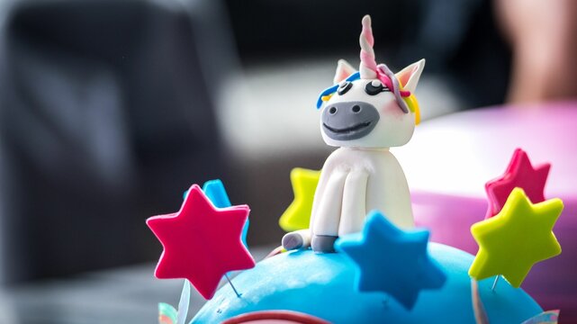 Fototapeta Closeup shot of an edible unicorn and colorful stars on a cake