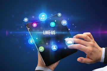 Businessman holding a foldable smartphone