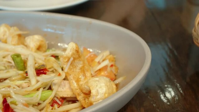 Closeup shot of a bowl with thai papaya salad