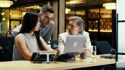 Diverse creative office workers talking and having working conference in modern office, using...