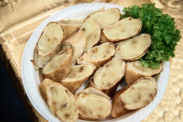 delicious pancakes with potatoes and herbs on a white plate