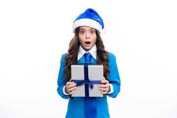 Santa child. Child with gift present box on isolated white background. Presents for birthday, Valentines day, New Year or Christmas. Surprised emotions of young teenager girl.