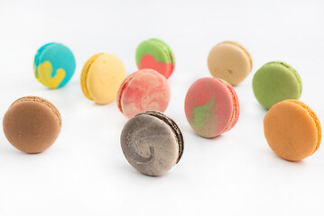 Blurred image of colorful macaroons on a light background.