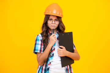 Teenager child painter in helmet with clipboard. Child in hard hat. Kid engineer on construction site. Renovation and repair.