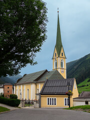 Fototapeta na wymiar Ischgl, Austria - July 25, 2022: Parish Church of Saint Nicholas in Ischgl