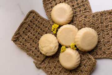Handmade soap is laid out on handmade washcloths. Natural cosmetics for body care.
