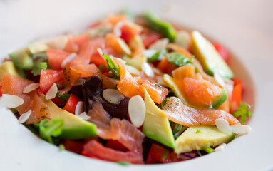 vegetable salad with hand salmon and avocado in a restaurant