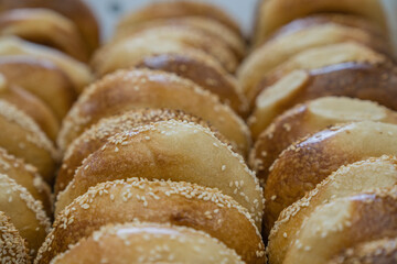 Close-up of freshly baked bagels with seeds on top. Selective focus.