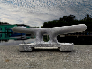 Close up of dock cleat with dramatic sky